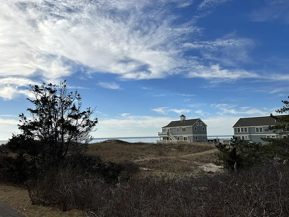 Cape Cod homes and winter sky beside Metcalf Memorial Beach in Dennis Port